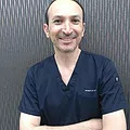 Dr. Tharwat Al-Izzi, BDS, DDS